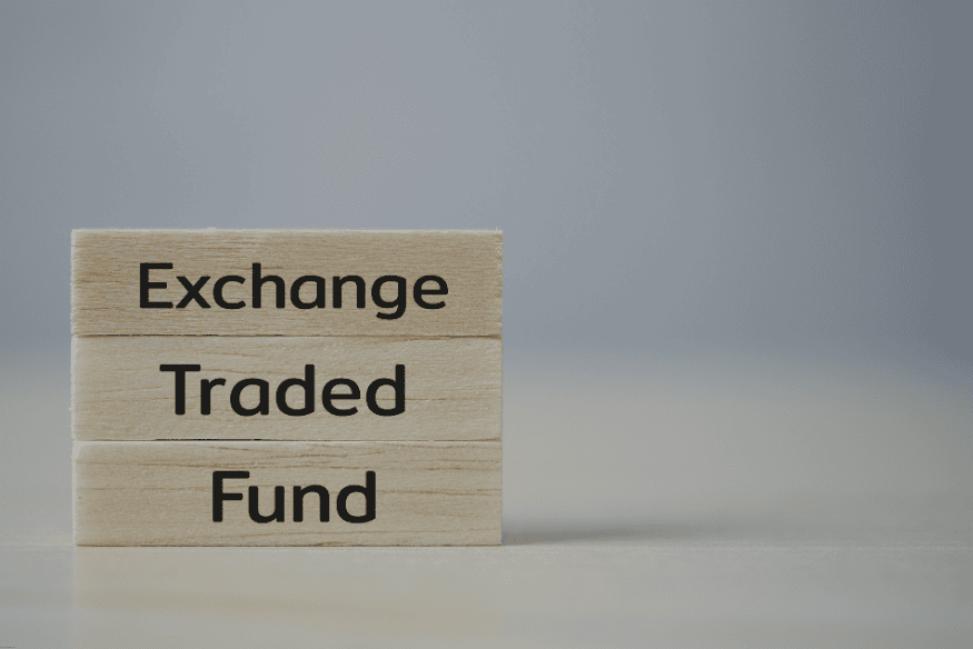 Wooden blocks spelling Exchange Traded Fund on gray background