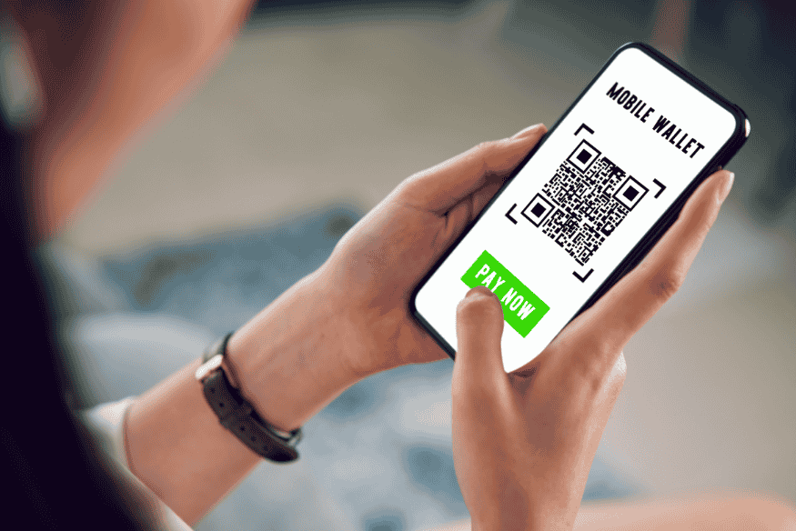 Person scanning a QR code to pay using a mobile wallet app in Asia.