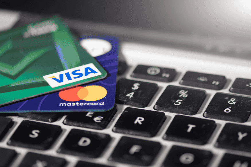 Visa and Mastercard credit cards placed on a laptop keyboard