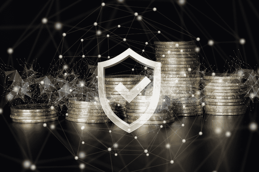 Digital shield icon over stacked coins representing financial protection and currency stability.