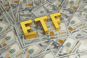 Golden ETF letters on US dollar bills representing investment growth