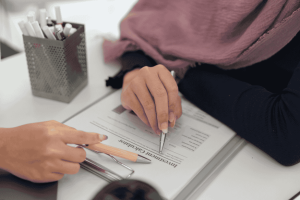 Two women reviewing investment documents for Sharia-compliant portfolio